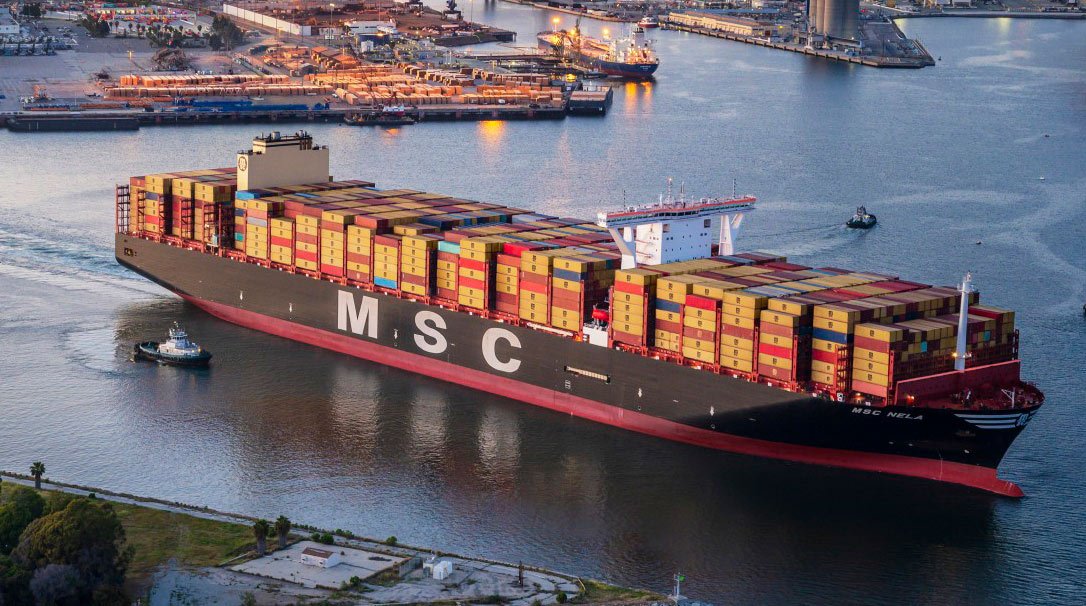 A large MSC container ship navigating through the harbor | MSC Cruises