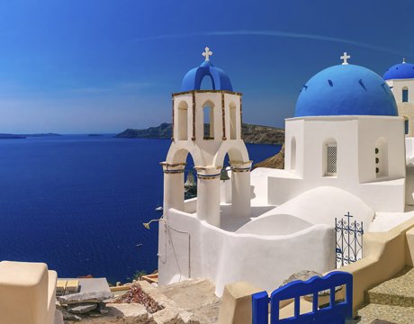 Santorini's iconic blue-domed churches overlooking the Aegean Sea | MSC Cruises Santorini's iconic blue-domed churches overlooking the Aegean Sea | MSC Cruises