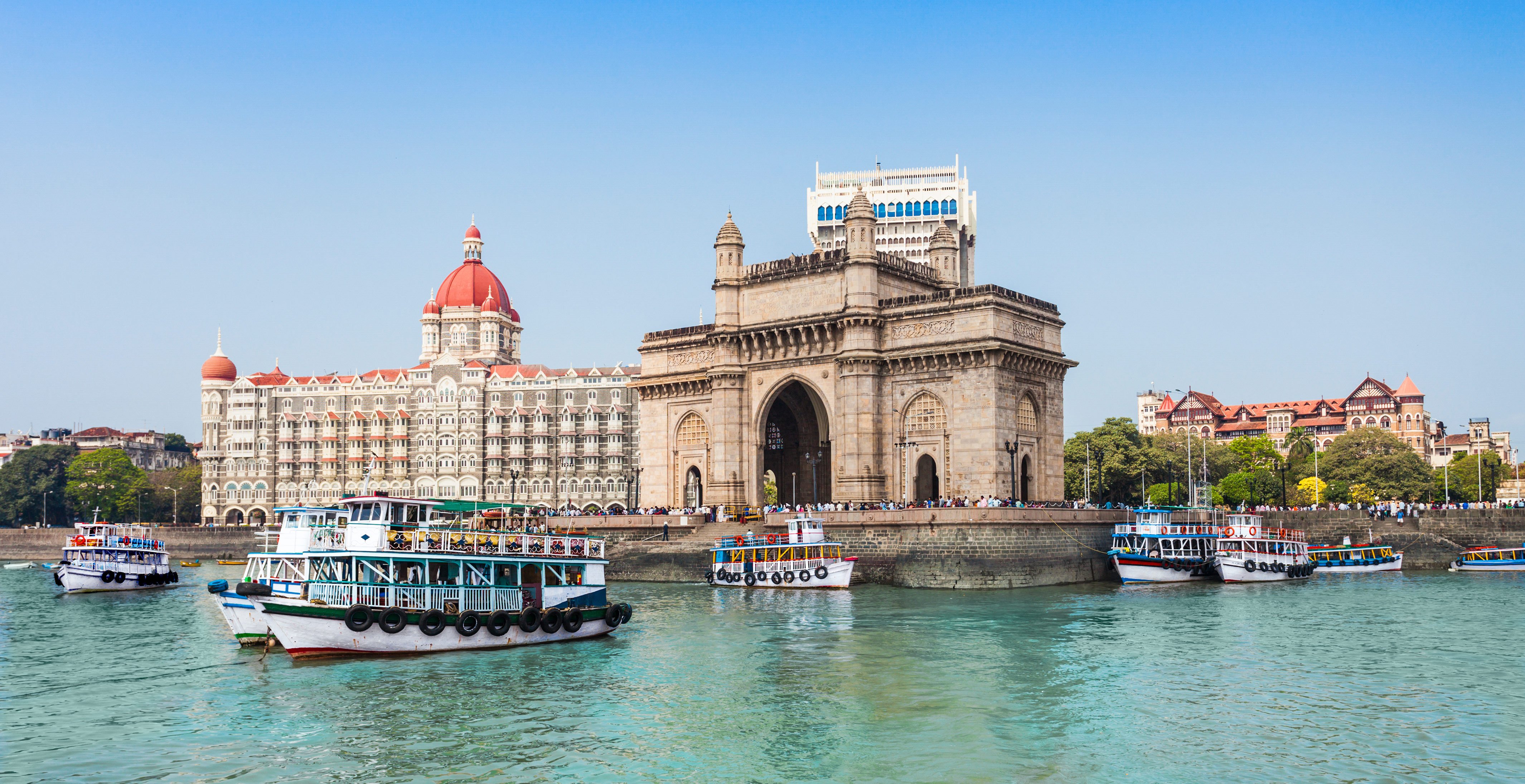 The Gateway of India and boats in Mumbai's harbor under a clear blue sky | MSC Cruises