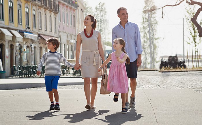 A family walking together in a charming European port town | MSC Cruises