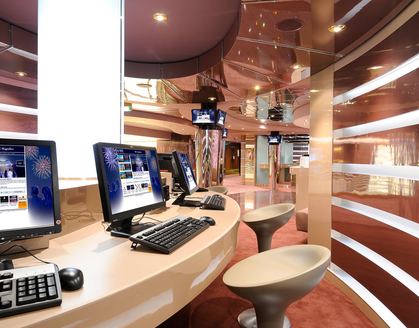 Modern internet café with sleek computers and stylish seating onboard | MSC Cruises Modern internet café with sleek computers and stylish seating onboard | MSC Cruises