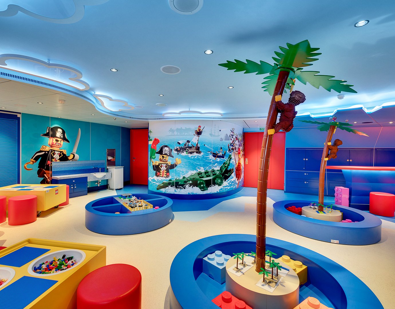 Colorful LEGO-themed kids' playroom with pirate decor and palm tree structures | MSC Cruises Colorful LEGO-themed kids' playroom with pirate decor and palm tree structures | MSC Cruises