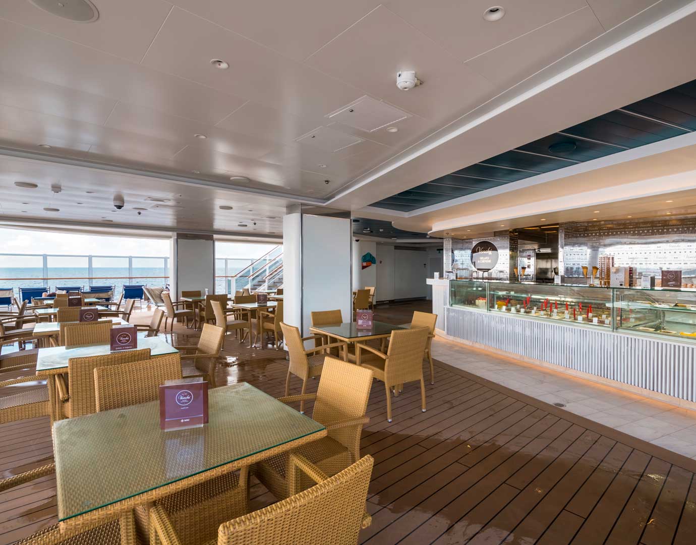 Outdoor gelato bar with wicker seating and ocean views on an MSC cruise ship | MSC Cruises Outdoor gelato bar with wicker seating and ocean views on an MSC cruise ship | MSC Cruises